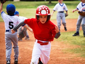 Little league baseball player running the bases 